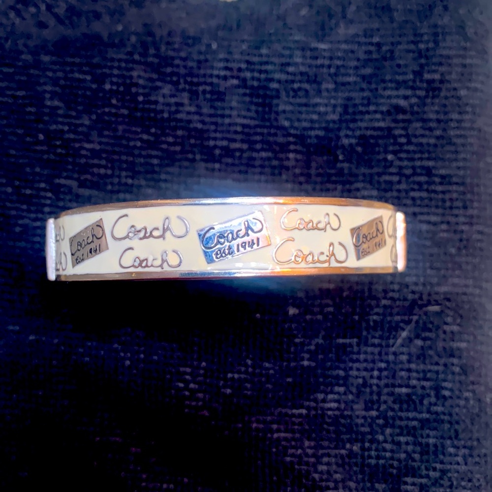 Coach bangle bracelet, white enamel, lightly used. Inner diameter approx 35 in.